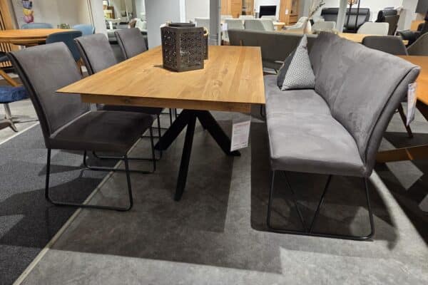 Esszimmer-Set mit Holztisch und grauen Stühlen in modernem Möbelgeschäft